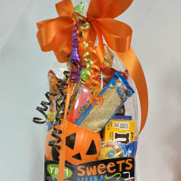 Halloween candy gift bag with an orange bow and pumpkin bucket