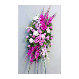 Tall pink and white floral standing spray on a metal easel