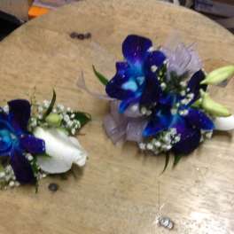 Blue and white floral corsages with ribbon accents