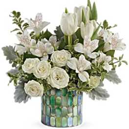 White tulips and roses arranged in a mosaic vase