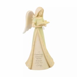 Angel figurine holding an open book with a quote on the dress