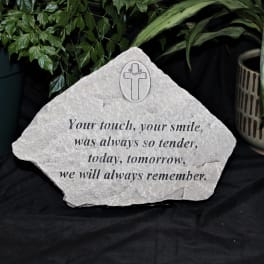 Memorial stone with a cross and remembrance message