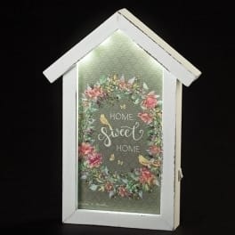 Framed house-shaped sign with floral wreath and "Home Sweet Home" text