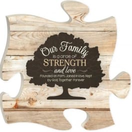 Wooden puzzle-piece sign with family quote and tree graphic