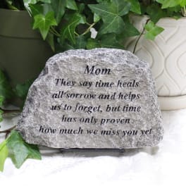 Engraved memorial stone with ivy leaves and a sympathy message for Mom