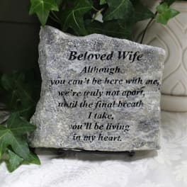 Engraved memorial stone with ivy leaves and a sympathy message