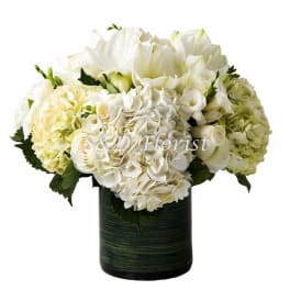 White floral arrangement in a dark green vase