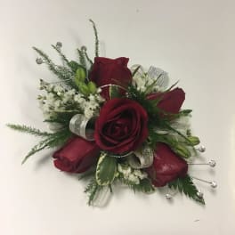 Red rose corsage with white filler and silver ribbon