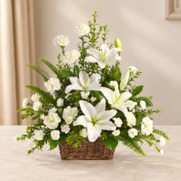 White lilies and carnations in a wicker basket