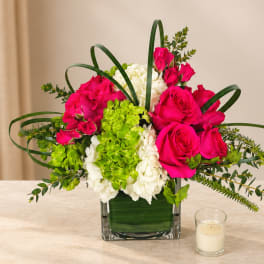 Pink roses and white hydrangeas in a square glass vase