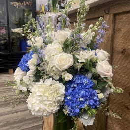 Blue and white floral arrangement in a glass vase