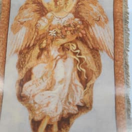Decorative angel figure holding a bouquet of flowers