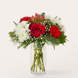 Red rose and white chrysanthemum bouquet in a clear glass vase