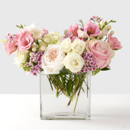 Pink and white roses in a clear glass vase