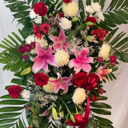 Standing floral spray with red roses and pink lilies