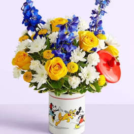 Bouquet of yellow roses, white daisies, and blue flowers in a Mickey Mouse tin