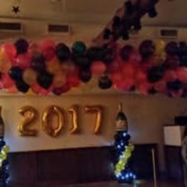 Balloon garland with gold "2017" numbers at an indoor party