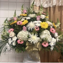Large standing floral spray with white, pink, and yellow flowers