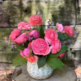 Pink ranunculus bouquet in a white textured vase