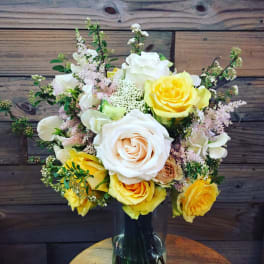 Bouquet of yellow and white roses in a glass vase