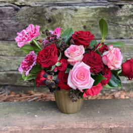 Bouquet of red and pink roses in a small vase