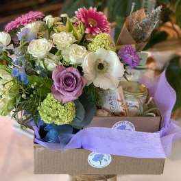Mixed bouquet with roses, anemones, and daisies in a gift box