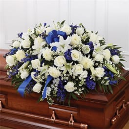 White and blue funeral spray on a casket