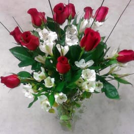 Bouquet of red roses and white alstroemeria in a clear glass vase
