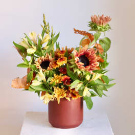 Sunflower and alstroemeria arrangement in a red vase