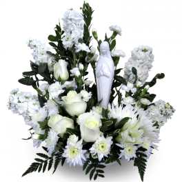 White floral arrangement with a small religious statue in the center