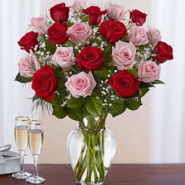 Bouquet of red and pink roses in a clear glass vase
