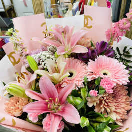 Pink lily and gerbera bouquet in pastel wrapping
