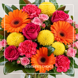 Bright mixed bouquet with orange gerberas, pink roses, and yellow pompons