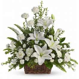 White lilies and carnations in a wicker basket