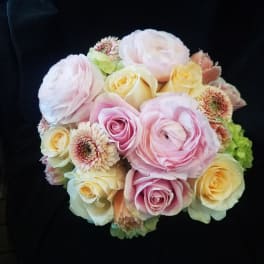 Bouquet of pale pink and cream roses with ranunculus and small daisy-like blooms