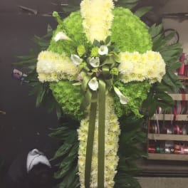 Large cross-shaped floral spray with white and green flowers
