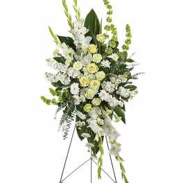 Tall white and pale yellow standing floral spray on a black metal easel