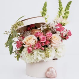 Pink and cream roses in a white hatbox with a glittery heart