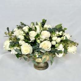 White rose bouquet in a gold pedestal vase