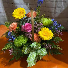Colorful floral basket with gerbera daisies, roses, and a green plaid bow