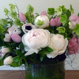 Pink and white floral arrangement in a green vase
