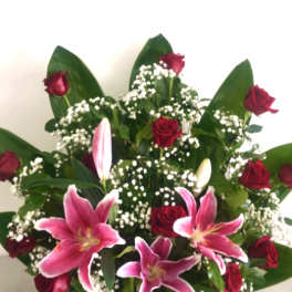 Bouquet of red roses and pink lilies with white baby's breath