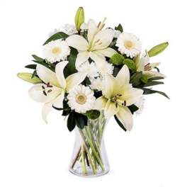 White lily and daisy bouquet in a clear glass vase