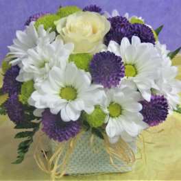 Bouquet of white daisies, purple blooms, and a pale yellow rose