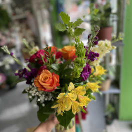 Handheld bouquet with orange roses and yellow alstroemeria