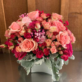 Pink and red rose bouquet in a white vase