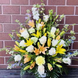 Large mixed floral arrangement with white roses and yellow lilies