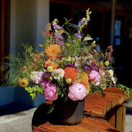 Colorful mixed bouquet in a dark vase
