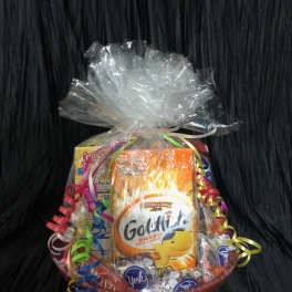 Gift basket with snack packages wrapped in clear cellophane and curled ribbons