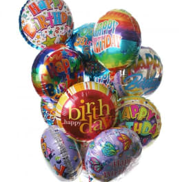 Cluster of colorful birthday balloons with printed messages